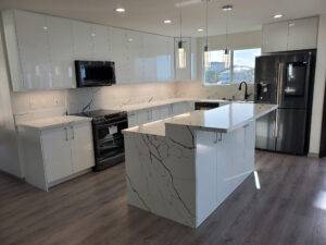 photo of a finished Hawaii home interior with light cabinetry, natural quartz counters